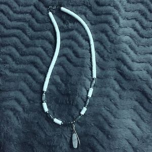 Lovely stone necklace mist charm that has a metal teardrop shape with a stone